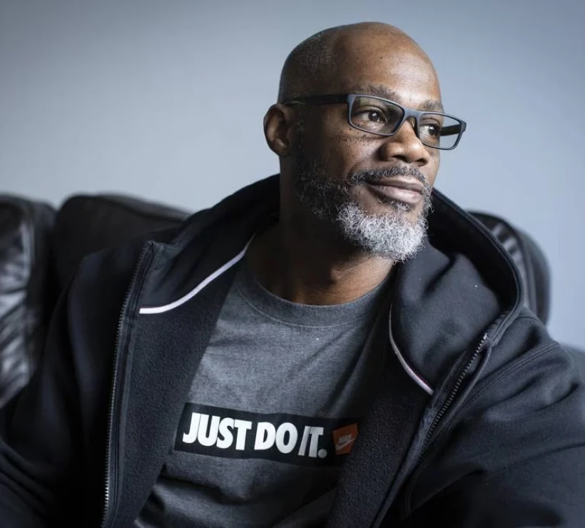 Adult black man with glasses looking pensive